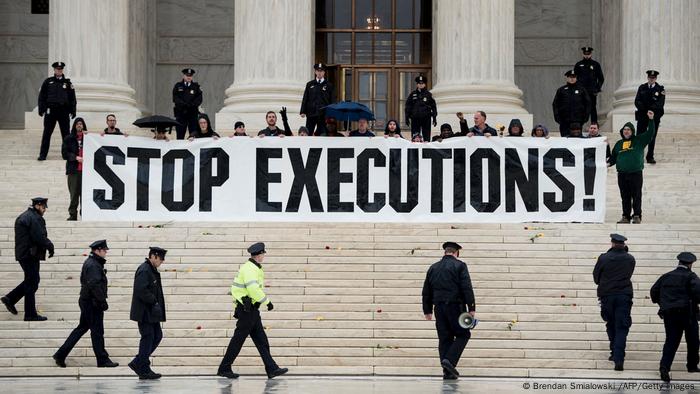 Police officers gather to remove activists during an anti death penalty protest in front of the US Supreme Court January 17, 2017 in Washington