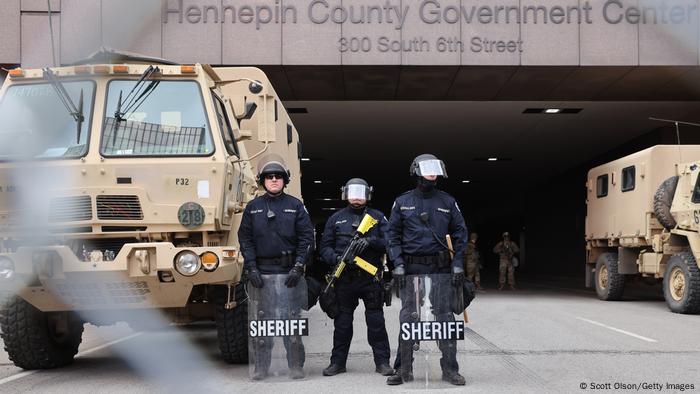 Police stand guard outside the Hennepin County courthouse