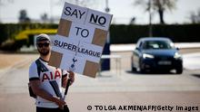 A Tottenham Hotspur's fan holds an anti-European Super League placard has he demonstrates outside the English Premier League football club's training ground in north London on April 19, 2021. - Arsenal and Tottenham Hotspur fans enjoy a fierce rivalry but the announcement of the European Super League achieved the rare feat of uniting them virtually as one in condemning it. (Photo by Tolga Akmen / AFP) (Photo by TOLGA AKMEN/AFP via Getty Images)