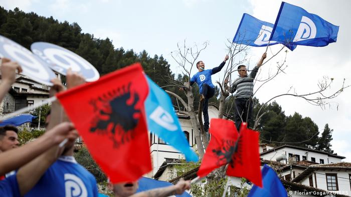 Supporters of the Socialist Party wave Albanian national flags during an election rally