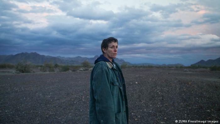 A still from Nomadland with Frances McDormand in a vast landscape.