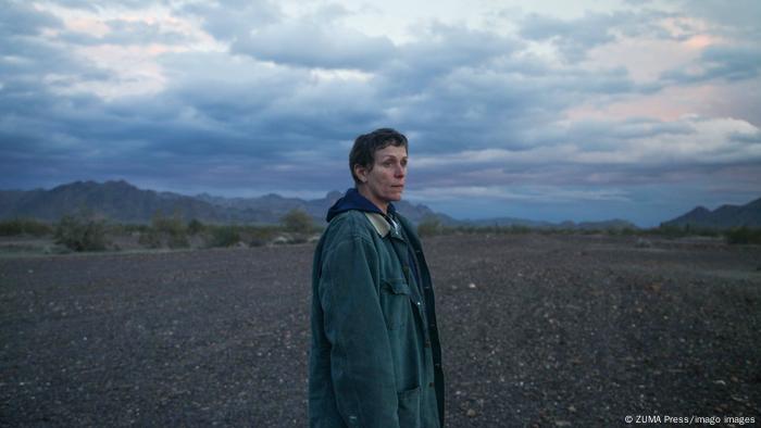 A still from Nomadland with Frances McDormand in a vast landscape.