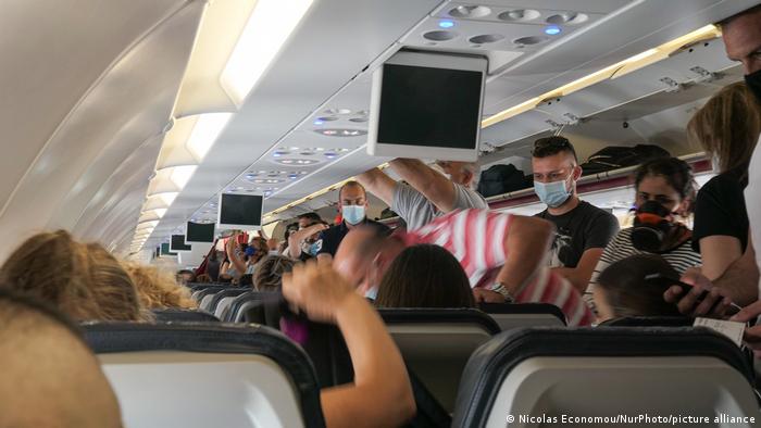Passengers with facemasks boarding a plane