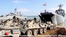 This handout photo taken from a video released on Friday, April 23, 2021 by Russian Defense Ministry Press Service shows, Russian military's armored vehicles roll into landing vessels after drills in Crimea. Russian Defense Minister Sergei Shoigu on Thursday ordered troops back to their permanent bases after a massive military buildup that caused Ukrainian and Western concerns. (Russian Defense Ministry Press Service via AP)