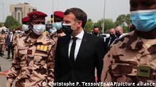 French President Emmanuel Macron, center, flanked by the son of the late Chadian president Idriss Deby, Mahamat Idriss Deby, left, arrives to attend the state funeral for the late Chadian president Idriss Deby in N'Djamena, Chad, Friday, April, 23, 2021. Chad's President Idriss Deby died of injuries suffered in clashes with rebels in the country's north, an army spokesperson announced on state television on 20 April 2021. Deby had been in power since 1990 and was re-elected for a sixth term in the 11 April 2021 elections. The state funeral will take place on the morning of April, 23, 2021, attended by French President Emmanuel Macron. (Christophe Petit Tesson / Pool photo via AP)