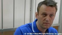 Russian top opposition leader Alexei Navalny attends hearings at a court house in Moscow on August 1, 2014. Russian prosecutors called for Navalny to be jailed on August 1 after allegedly using the Internet in breach of his house arrest conditions during a trial seen as politically motivated by his supporters. One of the most vocal critics of President Vladimir Putin, Navalny faces charges of stealing and laundering 27 million roubles ($760,000, 570,000 euros) from French cosmetics company Yves Rocher. He has been under house arrest since February and banned from using the Internet. AFP PHOTO / VASILY MAXIMOV (Photo by Vasily MAXIMOV / AFP) (Photo by VASILY MAXIMOV/AFP via Getty Images)