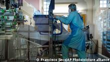 Medical personnel wearing protective equipments lift a COVID-19 patient with a small clinic crane in the intensive care ward of the CHU Liege hospital, in Liege, Belgium, Thursday, April 15, 2021. (AP Photo/Francisco Seco)