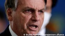 Brazilian President Jair Bolsonaro gives a press conference to announce the start of new emergency aid for the COVID-19 pandemic at Planalto presidential palace in Brasilia, Brazil, Wednesday, March 31, 2021. AP Photo/Eraldo Peres)