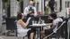 server wears a face mask as he takes an order at an outdoor terrace in Montreal server wears a face mask as he takes an order at an outdoor terrace in Montreal