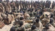 This image made available courtesy of the Chadian Army on April 18, 2021, shows alleged rebel soldiers belonging to the Front pour l’alternance et la concorde au Tchad (FACT) sitting in the sand after having been captured following clashes with the Chadian army in Nyze, 50km North east of Zigueye, on April 17, 2021. (Photo by - / Chadian Army / AFP) / RESTRICTED TO EDITORIAL USE - MANDATORY CREDIT AFP PHOTO/Chadian Army - NO MARKETING - NO ADVERTISING CAMPAIGNS - DISTRIBUTED AS A SERVICE TO CLIENTS