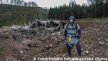 epa04524853 A handout photo provided on 11 December 2014 by the Police of the Czech Republic shows a pyrotechnician inspecting damaged private ammunition depots near Vrbetice, eastern Moravia, Czech Republic, 20 October 2014. The Czech authorities are investigating explosions at the depot which occurred on October 16 and December 03 in eastern Moravia. EPA/CZECH REPUBLIC POLICE / HANDOUT HANDOUT EDITORIAL USE ONLY ++ +++ dpa-Bildfunk +++