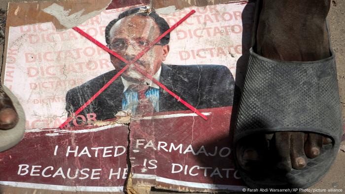 A foot tramples on a poster bearing Somalia's President Mohamed Abdullahi Farmaajo's image.