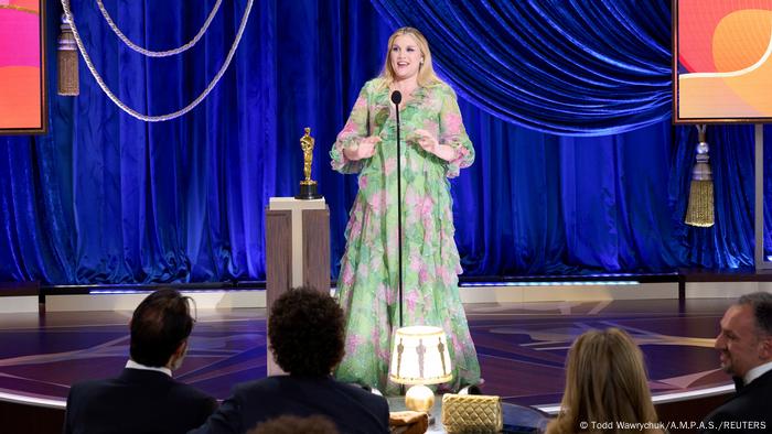 Emerald Fennell on stage accepting the award for best original screenplay.