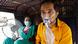 A patient wearing an oxygen mask looks on as his wife holds a battery-operated fan while waiting inside an auto-rickshaw to enter a COVID-19 hospital for treatment A patient wearing an oxygen mask looks on as his wife holds a battery-operated fan while waiting inside an auto-rickshaw to enter a COVID-19 hospital for treatment