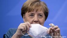 *** Dieses Bild ist fertig zugeschnitten als Social Media Snack (für Facebook, Twitter, Instagram) im Tableau zu finden: Fach „Images“ —> Weltspiegel/Bilder des TagesBERLIN, GERMANY - APRIL 26: German Chancellor Angela Merkel, puts on protective mask after speaking to the media following a virtual vaccine summit during the coronavirus pandemic on April 26, 2021 in Berlin, Germany. The supply of vaccines and the pace of inoculations is accelerating significantly in Germany, leading some states to push for opening up vaccinations to people not on the current priority lists. Politicians are also debating rights for those who have been vaccinated versus those who have not. (Photo by Maja Hitij/Getty Images)