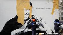 Workers paint over a graffiti depicting jailed Russian opposition politician Alexei Navalny in Saint Petersburg, Russia April 28, 2021. The graffiti reads: The hero of the new age. REUTERS/Anton Vaganov