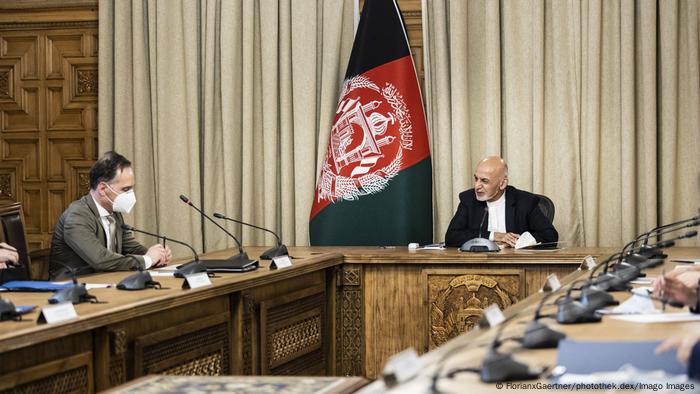 Two men at a desk for talks