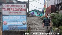 A board that says welcome to Nepal in Manebhanjyang, India, on April 19, 2021. Mane Bhanjang lies on the border between India and Nepal. The two countries are separated by a small culvert, which also acts as a motor stand for vehicles ferrying people to Sukhiapokhri and Darjeeling. Perched at an elevation of 1928m, 28 km from Darjeeling on the foothills of the highest point of West Bengal is a quaint transit town called Manebhanjang. April 19, 2021. (Photo by Nishal Lama/NurPhoto)