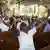 A man raises his arms during a Catholic mass in Port-au-Prince, Haiti