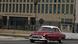 The US Embassy in Havana with an old car driving in front The US Embassy in Havana with an old car driving in front