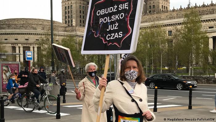 Anna Labus and Krystyna Piotrowska holding signs during a protest in Warsaw