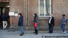 Voters, wearing protective face masks and keeping social distance, queue outside a polling station during Madrid's Regional elections, in Madrid, Spain, May 4, 2021. REUTERS/Susana Vera
