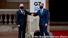 German Foreign Affairs Minister Heiko Maas, left, is greeted by Britain's Foreign Secretary Dominic Raab at the start of the G7 foreign ministers meeting in London Tuesday May 4, 2021. G7 foreign ministers meet in London Tuesday for their first face-to-face talks in more than two years. (Ben Stansall / Pool via AP)