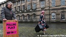Council staff carry ballot boxes and a sign to a van as they prepare to deliver them to polling stations ahead of Scottish parliamentary election held on May 6, at the Royal Mile, Edinburgh, Scotland, Britain, May 4, 2021. REUTERS/Russell Cheyne