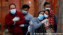 FILE PHOTO: Family members mourn a coronavirus disease (COVID-19) victim as the country recorded the highest daily increase in death since the pandemic began, in Kathmandu, Nepal May 3, 2021. REUTERS/Navesh Chitrakar/File Photo