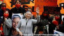 Tran To Nga, a 78-year-old former journalist, waves as she delivers a speech during a gathering in support of people exposed to Agent Orange during the Vietnam War, in Paris, Saturday Jan. 30, 2021. Activists gathered Saturday in Paris in support of people exposed to Agent Orange during the Vietnam War, after a French court examined a case opposing a French-Vietnamese woman to 14 companies that produced and sold the toxic chemical. (AP Photo/Thibault Camus)