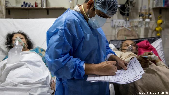 A doctor in India takes care of elderly COVID patients