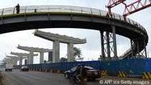 Motorists drive on Mombasa road, past ongoing construction site of the Nairobi Expressway, undertaken by the Chinese contractor China Road and Bridge Corporation (CRBC), in Nairobi on February 10, 2021. (Photo by Simon MAINA / AFP) (Photo by SIMON MAINA/AFP via Getty Images)