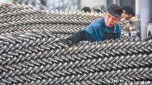 A worker sets up wheels at a factory in Hangzhou in China's eastern Zhejiang province on April 16, 2021. - - China OUT (Photo by STR / AFP) / China OUT (Photo by STR/AFP via Getty Images)
