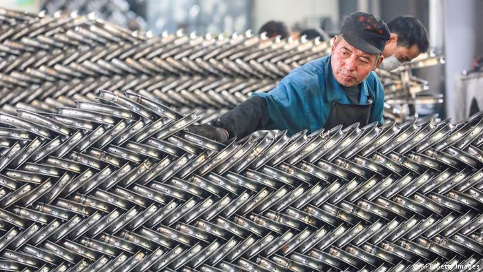 A wroking setting up wheels at a factory in Hangzhou, China