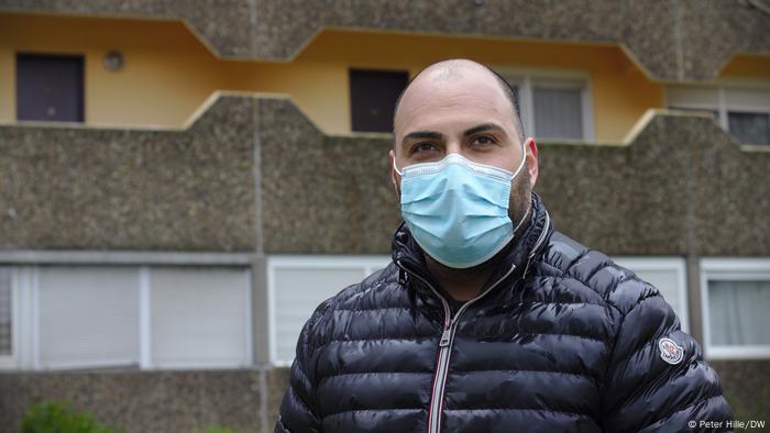 A man wearing a black coat and a face mask, no hair A man wearing a black coat and a face mask, no hair