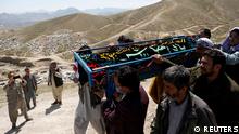Men carry the coffin of one of the victims of yesterday's explosion during a mass burial ceremony in Kabul, Afghanistan May 9, 2021. REUTERS/Stringer