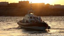 Rescued migrants are being transfered at the commercial port of Lampedusa on August 29, 2020 from the Coast Guard patrol boat CP-319, which transhipped rescued migrants from the civilian rescue boat Louise Michel 50 miles southeast of the Italian pelagic island. - An Italian coastguard vessel came to the rescue on August 29, 2020 of rescue vessel Louise Michel funded by British street artist Banksy, which sent out a distress signal on with more than 200 migrants onboard. (Photo by Mauro Seminara / AFP) (Photo by MAURO SEMINARA/AFP via Getty Images)