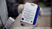 Medical personnel holds a pack of ampules of the Russian Sputnik-V, The first registered vaccine against COVID-19, for photographer in Golestan hospital in the city of Ahvaz 817Km (508 miles) south of Tehran in Khouzestan province on March 14, 2021. (Photo by Morteza Nikoubazl/NurPhoto)