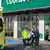 First responders take a victim to an ambulance outside a Countdown supermarket in central Dunedin