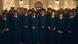 A scene from 'The Underground Railroad': the image is filled with Black people wearing train conductor uniforms, along with passengers behind them, all facing the camera. A scene from 'The Underground Railroad': the image is filled with Black people wearing train conductor uniforms, along with passengers behind them, all facing the camera.