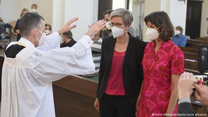 Priest Wolfgang Rothe blesses a same-sex couple