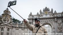 On 18 April 2021, tourists enjoyed relatively empty streets and historic attractions in Istanbul, Turkey, as most of the city's residents followed weekend curfews and social distancing measures in effort to reduce a recent surge in Covid-19 cases. Above, a tourist takes a selfie in front of the Ottoman-era Dolmabache Palace. (Photo by Diego Cupolo/NurPhoto)