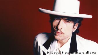 Bob Dylan wearing a white suit and white hat.