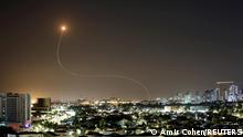 A streak of light is seen as Israel's Iron Dome anti-missile system intercepts rockets launched from the Gaza Strip towards Israel, as seen from Ashkelon, Israel May 11, 2021. REUTERS/Amir Cohen 