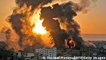 TOPSHOT - A fire rages at sunrise in Khan Yunish following an Israeli airstrike on targets in the southern Gaza strip, early on May 12, 2021. - Israeli air raids in the Gaza Strip have hit the homes of high-ranking members of the Hamas militant group, the military said Wednesday, with the territory's police headquarters also targeted. (Photo by YOUSSEF MASSOUD / AFP) (Photo by YOUSSEF MASSOUD/AFP via Getty Images) 