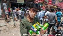 May 11, 2021, Ghaziabad, Uttar Pradesh, India: A young man seen carrying several beer cans following the reopening of Liquor Shops in several districts of Uttar Pradesh. .Liquor shops have been allowed to operate from 10am to 7pm amid the COVID19 pandemic. In last 24 hours Uttar Pradesh has recorded 21,277 Positive COVID19 cases and 278 deaths. (Credit Image: © Pradeep Gaur/SOPA Images via ZUMA Wire