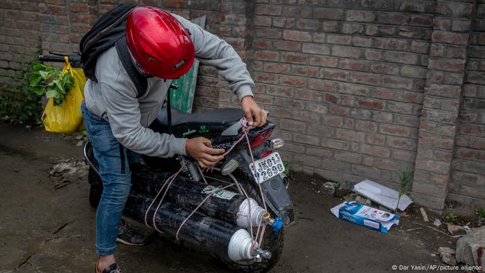 Indian man with oxygen cylinders