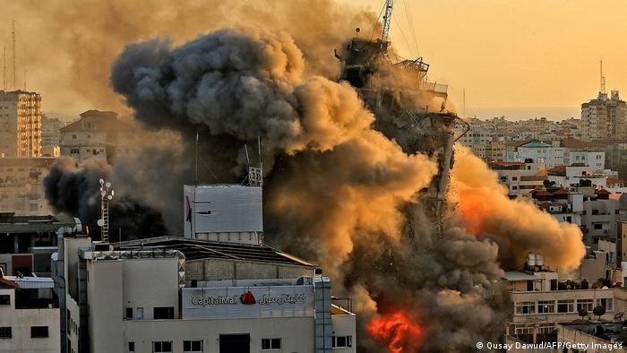 Heavy smoke and fire rise from Al-Sharouk tower as it collapses after being hit by an Israeli air strike