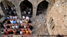 People attend Eid al-Fitr prayer marking the end of the holy fasting month of Ramadan, at the oldest Al-Masfi mosque, which was damaged during the war against Islamic State militants in Mosul, Iraq May 13, 2021. REUTERS/Abdullah Rashid