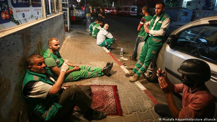 Palestinian medical staff take a break outside Shifa Hospital